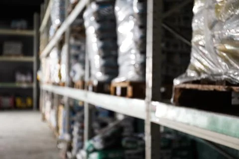Blurred view of storage stands with different building materials in wholesale Fotos de archivo