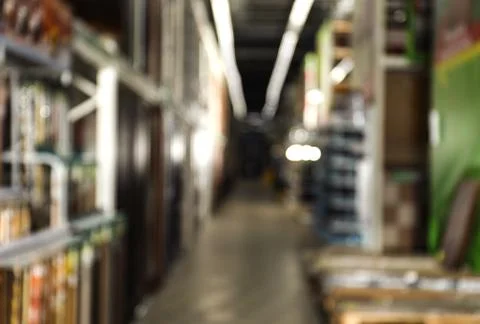 Blurred view of storage stands with different building materials in wholesale Fotos de archivo