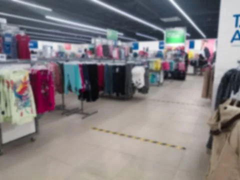 Blurred view of a store with clothes. Stock Photos