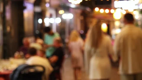 A blurred view of a street restaurant in the evening, decorated with garlands Stock Footage 324874158