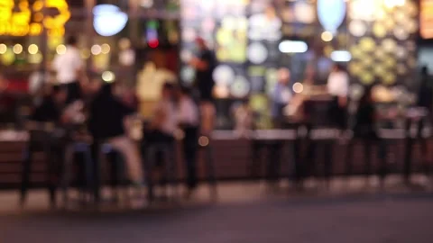 Blurred view of a street restaurant in the evening decorated with garlands Stock Footage 336664018