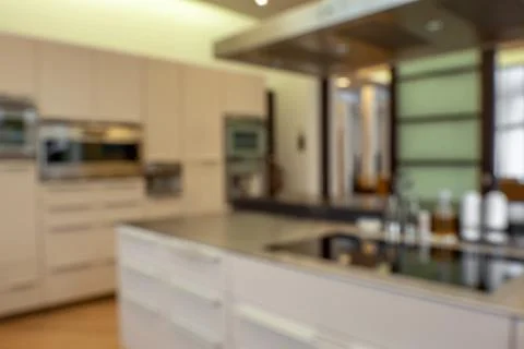 Blurred view of stylish functional kitchen with modern furniture and appliances Stock Photos