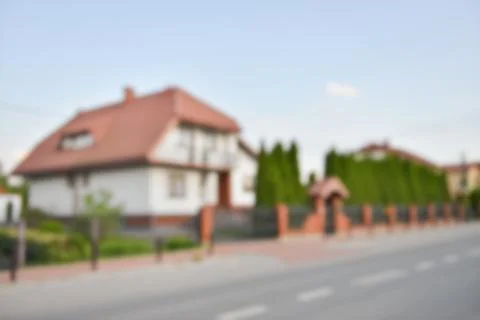 Blurred view of suburban street with beautiful house Stock Photos