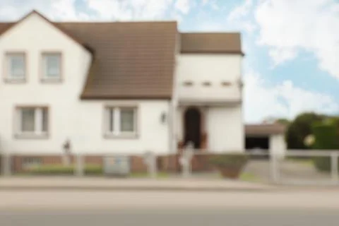 Blurred view of suburban street with beautiful house Stock Photos