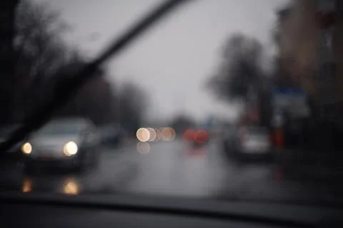 Blurred view through a car windshield with bokeh lights from oncoming traff.. Stock Photos