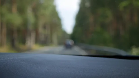 Blurred view through the front window of the car. The car goes on a country road Video stock 101783271