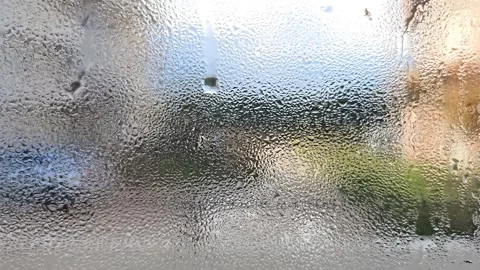 Blurred view through a glass surface covered with water droplets, condensation Stock Footage 297012741