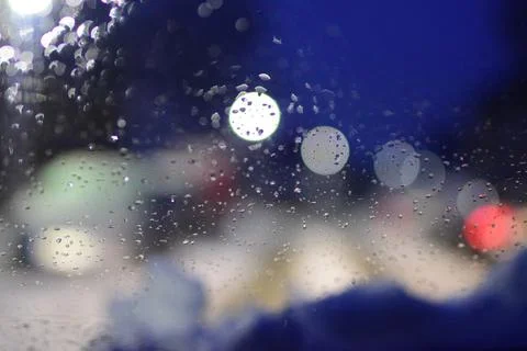 Blurred view through windshield on wintry road with snow on the hood Stock Photos