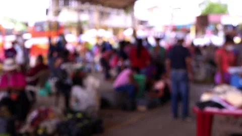 A blurred view of an unrecognisable crowd of people walking at a street market Stock Footage 153720609