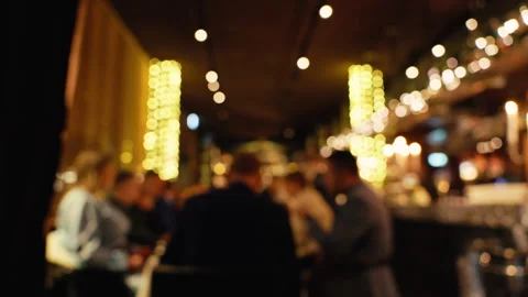 A Blurred View of a Vibrant Restaurant Scene, Showcasing Warm Ambient Lighting Stock Footage 295862257