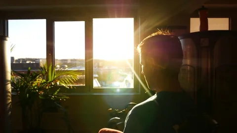 Blurred view of a young man working out in a gym in sun rays from the window Stock Footage 70845614