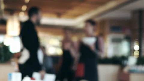 Blurred waitress comes to the table, gives the visitors a menu goes for drinks Stock Footage 100734973