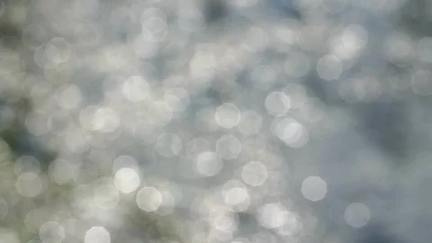 Blurred water at shiny sunlight creates bokeh background Stock Footage 122943347