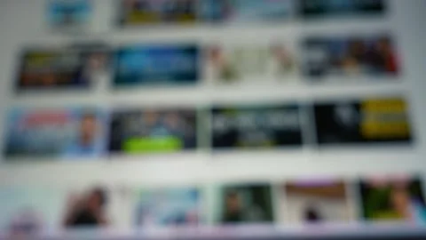 Blurred web page with rows of thumbnail images on a screen moving, suggesti.. Видео 337899171