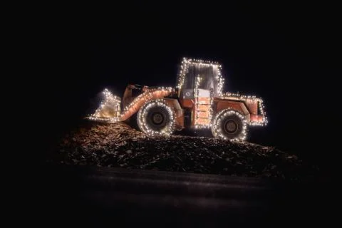 Blurred wheel loader decorated with lights Stock Photos
