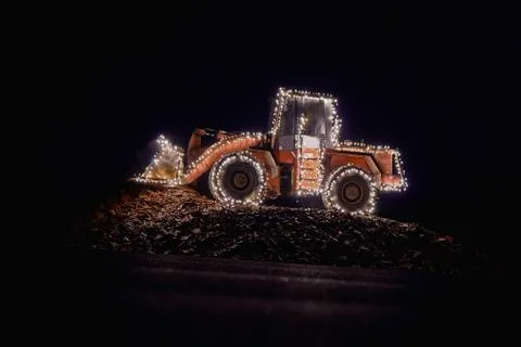 Blurred wheel loader decorated with lights Stock Photos