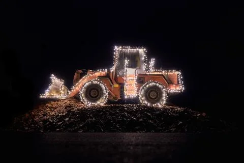 Blurred wheel loader decorated with lights Stock Photos