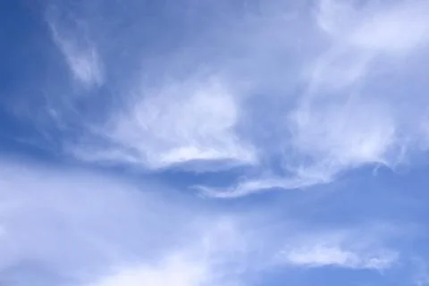 Blurred white clouds on the sky background. Stock Photos