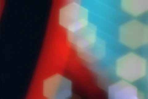Blurred white hexagonal neon lights flashing over colored lights in background Stock Footage 86884973