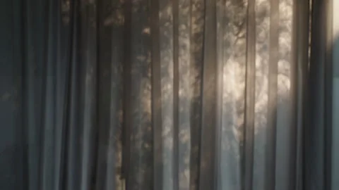 Blurred white sheer curtains with sunlight and gentle moving tree shadows. Stock Footage 330150037