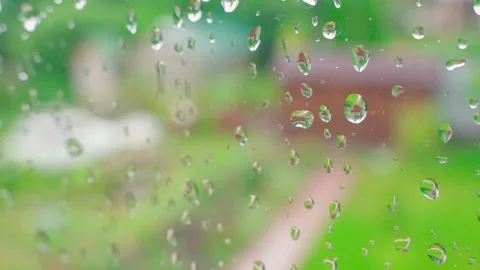 Blurred window background on a rainy autumn day. Water drops on glass close up Stock Footage 252270294