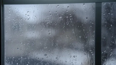 Blurred Winter landscape through the window in house. falling snow outside on Stock Footage 293891024