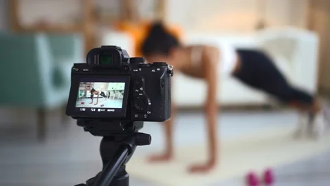 Blurred of woman doing exercise in front of camera phone in apartment interior. Video stock 158361232
