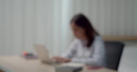 Blurred young woman working with laptop and smartphone Stock Footage 127084053