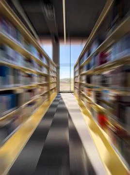 Blurred zoom view of corridor between bookshelves in library Stock Photos