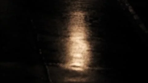 Blurry, abstract footage of rain fall on city street asphalt at night. Video stock 320099439