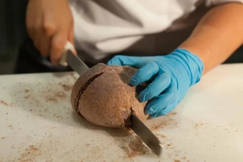 Blurry background of the chef is cutting the bread on the white plastic cutti Stock Photos