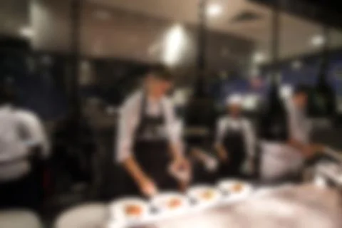 Blurry background of Chef in hotel or restaurant kitchen cooking and decorati Stock Photos