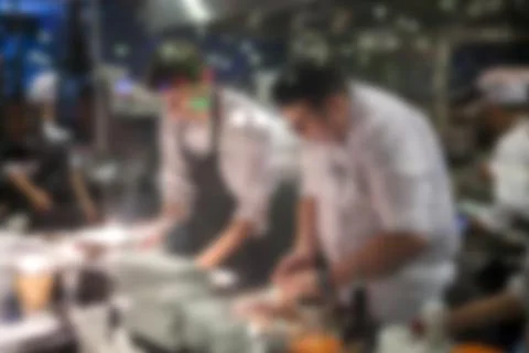 Blurry background of Chef in hotel or restaurant kitchen cooking and decorati Stock Photos