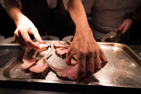 Blurry background of Chef in hotel or restaurant kitchen cooking with lamb an Stock Photos