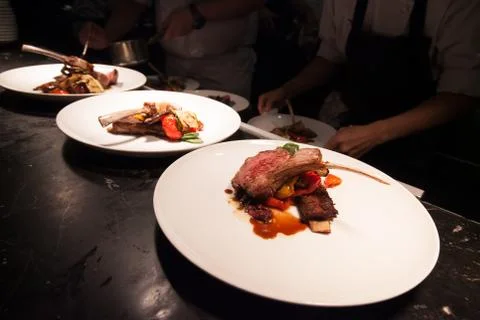 Blurry background of Chef in hotel or restaurant kitchen cooking with lamb an Stock Photos