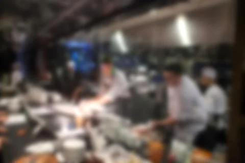 Blurry background of Chef in hotel or restaurant kitchen cooking and decorati Stock Photos