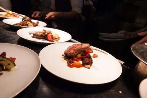 Blurry background of Chef in hotel or restaurant kitchen cooking with lamb an Stock Photos