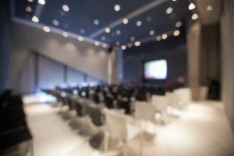 Blurry background of seminar room empty with bokeh of ceiling light. Stock Photos