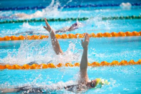 Blurry background of splash drop water on swimming race with swimming competi Stock Photos