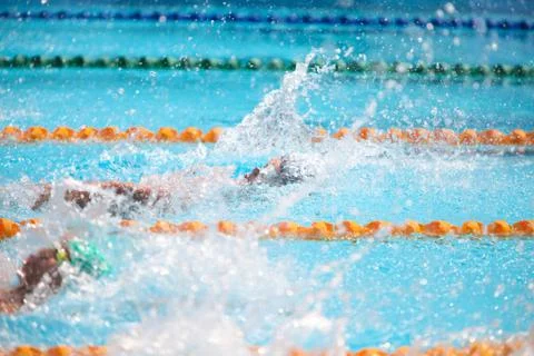 Blurry background of splash drop water on swimming race with swimming competi Stock Photos