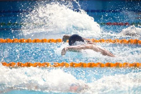 Blurry background of splash drop water on swimming race with swimming competi Stock Photos