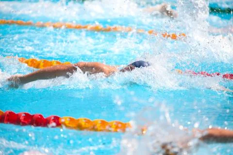 Blurry background of splash drop water on swimming race with swimming competi Stock Photos