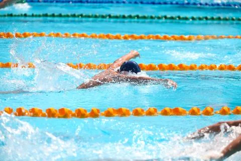 Blurry background of splash drop water on swimming race with swimming competi Stock Photos