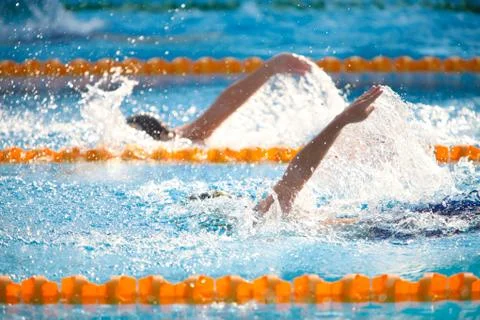 Blurry background of splash drop water on swimming race with swimming competi Stock Photos