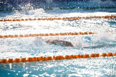 Blurry background of splash drop water on swimming race with swimming competi Stock Photos