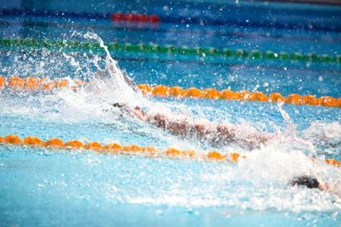 Blurry background of splash drop water on swimming race with swimming competi Stock Photos