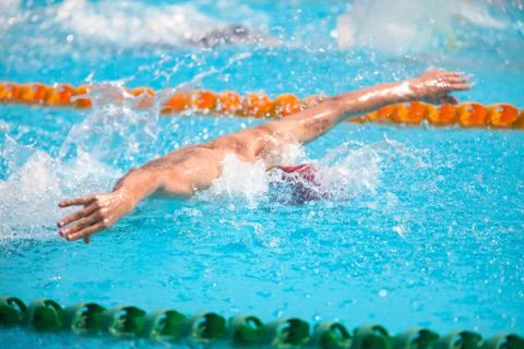 Blurry background of splash drop water on swimming race with swimming competi Stock Photos