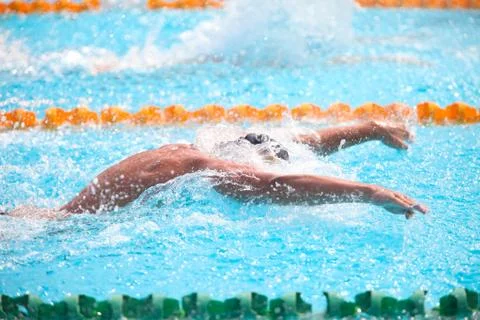 Blurry background of splash drop water on swimming race with swimming competi Stock Photos