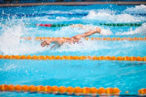 Blurry background of splash drop water on swimming race with swimming competi Stock Photos