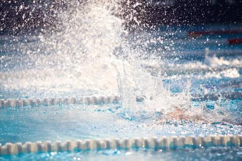 Blurry background of splash drop water on swimming race. Stock Photos